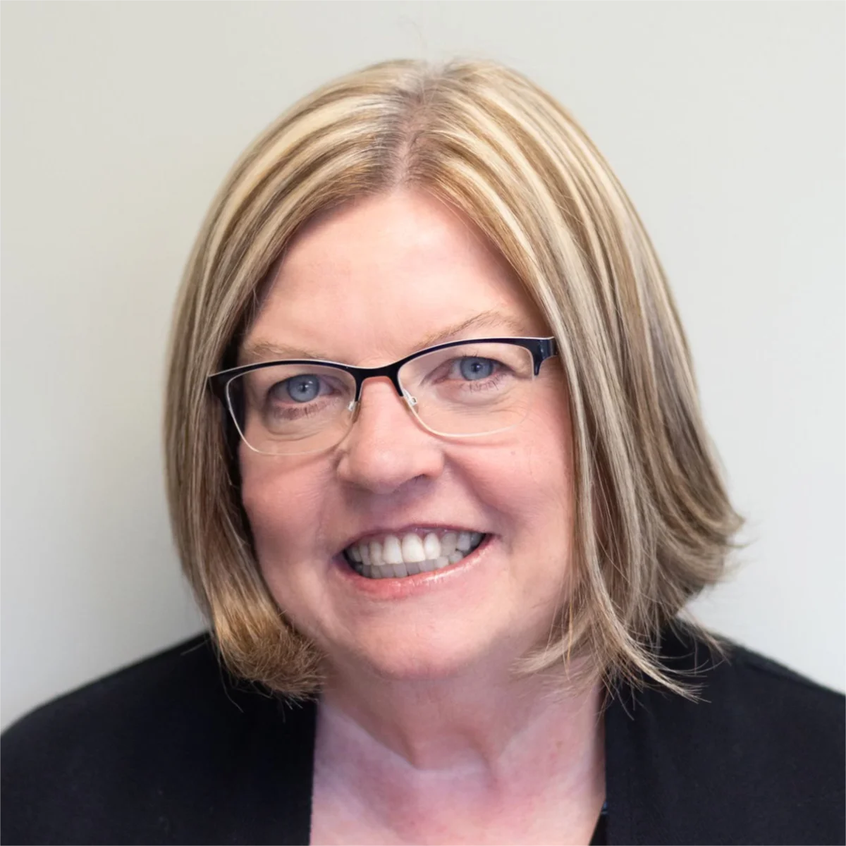 A profile picture of Tracy Monroe, CPA at Monroe & Company. A person with short, light brown hair and glasses smiles at the camera.